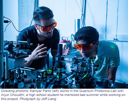 Kamyar Choudhry mentors a high school student in the Quantum Photonics Lab.