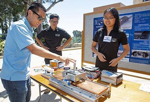 Hyperloop team members demonstrate their technology.