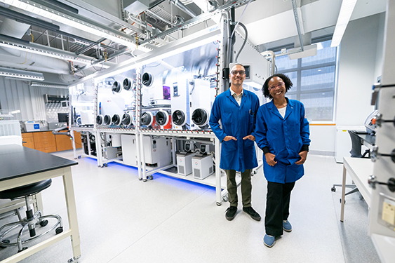 Researchers stand in front of NSF ExFAB BioFoundry Anaerobic Chamber