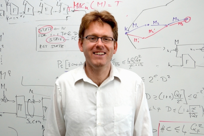 Stefano Tessaro by a whiteboard of equations