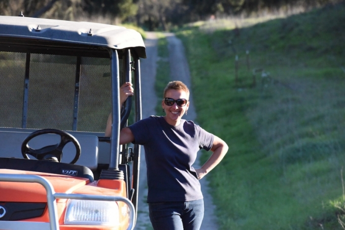 Professor Chandra Krintz by a tractor