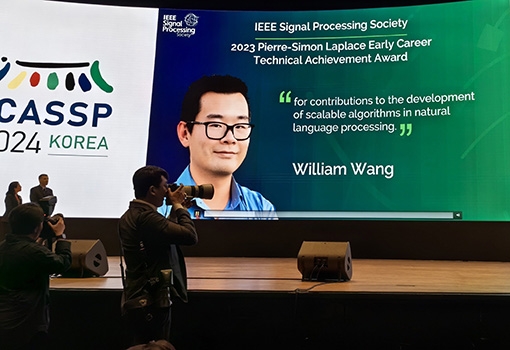 Photo of William Wang at an even recognizing his award.