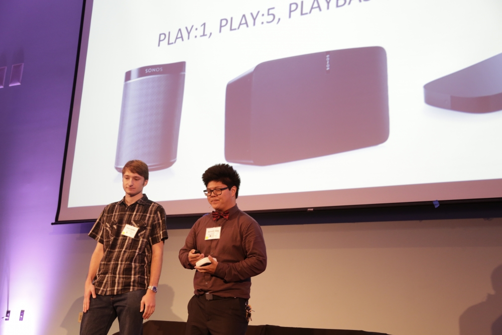 Members of SONOS COM present their project on stage